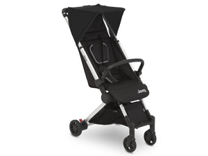 Collapsed travel stroller next to a grocery bag 130