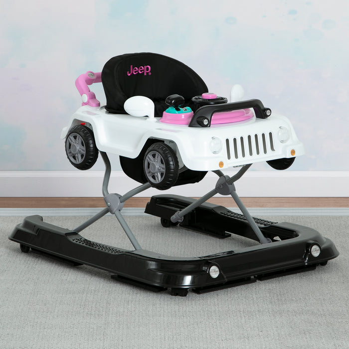 A green Jeep Wrangler baby walker designed for toddlers, featuring a toy tray and interactive features. 2-Jeep® Classic Wrangler 3-in-1 Grow With Me Walker