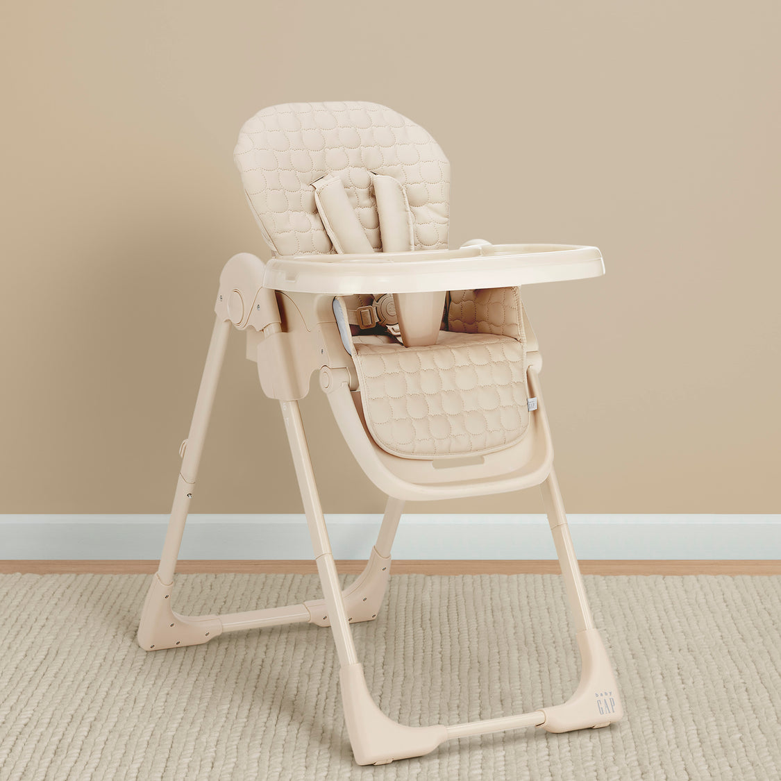 Beige high chair on a beige carpet with a beige wall background