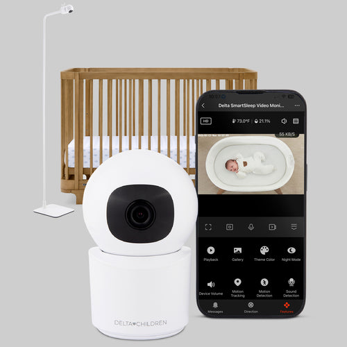 Baby monitor with smartphone displaying video feed in a bedroom setting