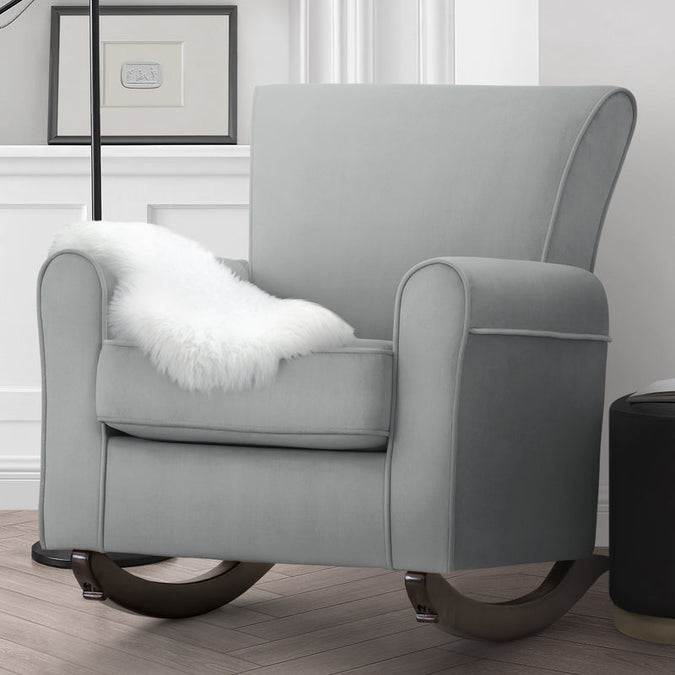 Gray rocking chair with a white fur pillow in a room setting. 20-Lancaster Rocking Chair featuring LiveSmart Fabric by Culp