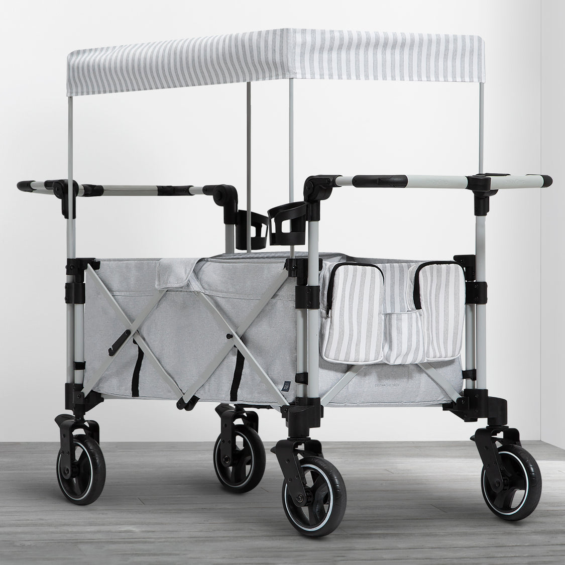 Foldable stroller with canopy on a wooden floor