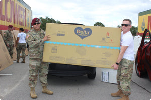 Soliders holding a Delta Children package 1 3