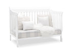 White crib with white bedding and gray mattress cover on a white background 37-Canton 4-in-1 Crib