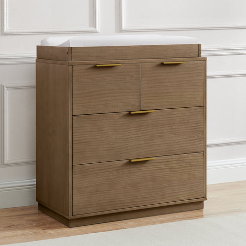 Wooden dresser with three drawers and a white countertop against a neutral wall.