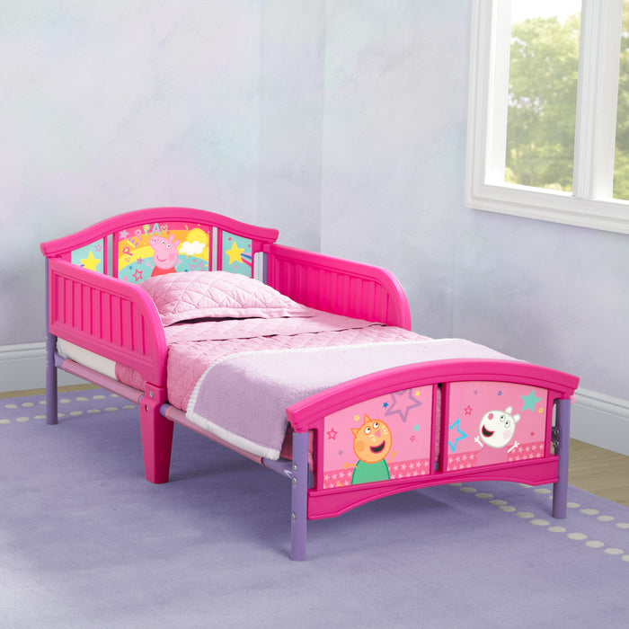 A toddler-sized bed with Peppa Pig character print, featuring bright pink and purple colors and two attached guardrails. 0-Peppa Pig Big Adventures Plastic Toddler Bed
