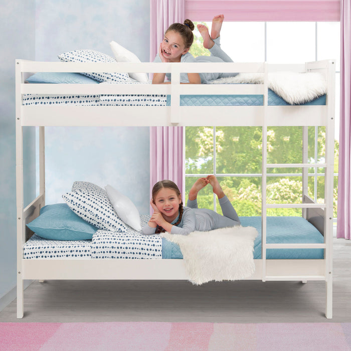 Two children playing on a white bunk bed with blue bedding in a room with pink curtains and a window. 3-Convertible Twin Bunk Bed with Ladder and Guardrails