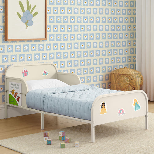 Children's bed with cartoon character stickers in a room with floral wallpaper.