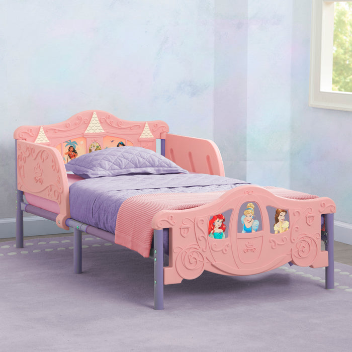 Pink princess-themed children's bed with purple bedding in a room. 1-Disney Princess 3D Toddler Bed