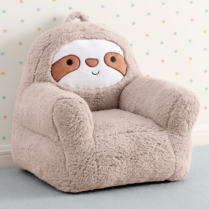 Plush sloth-shaped chair on a light blue surface with a star-patterned wall in the background 1-Sloth Cozee Buddy Chair