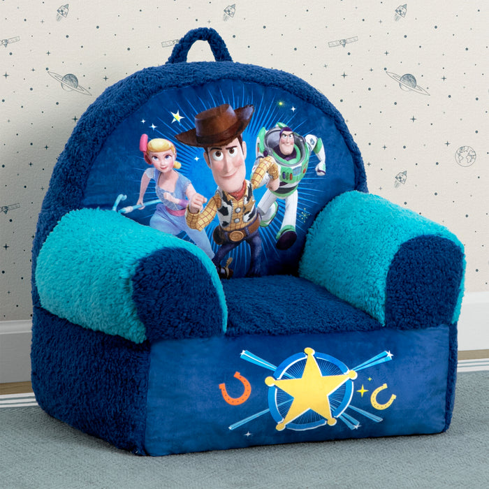 A blue plush chair with Toy Story character graphics, featuring a backpack-style backrest and a handle. 2-Toy Story Cozee Buddy Chair