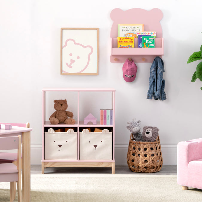 Children's room with pink bookshelf, teddy bear toys, and storage bins. 43-Brannan Bear Bookcase with Bins