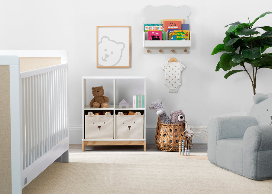 Nursery room with crib, bookshelf, and toys on a light wood floor. 40-Brannan Bear Bookcase with Bins