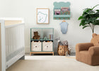 Nursery room with white crib, bookshelf, and armchair. 26-Brannan Bear Bookcase with Bins