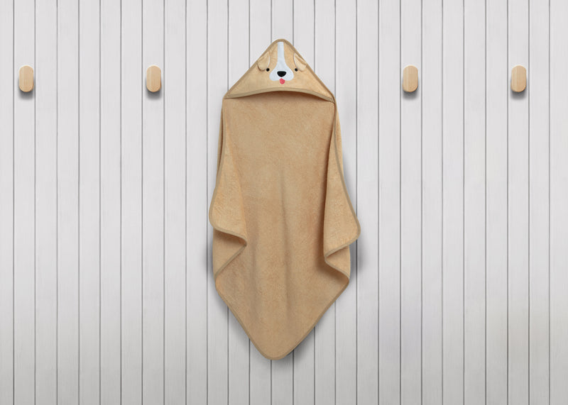 Beige hooded towel with bear design on a wooden background