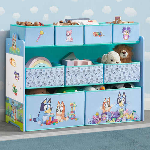 Children's toy storage unit with cartoon designs on a blue wall background