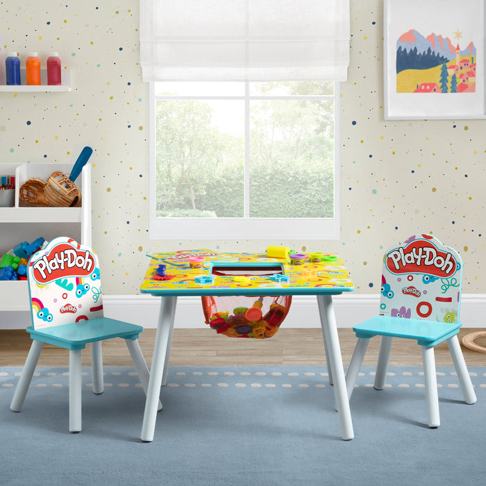 Children's Play-Doh table and chairs set in a room with colorful decor. 3-Play-Doh Table and 2 Chair Set
