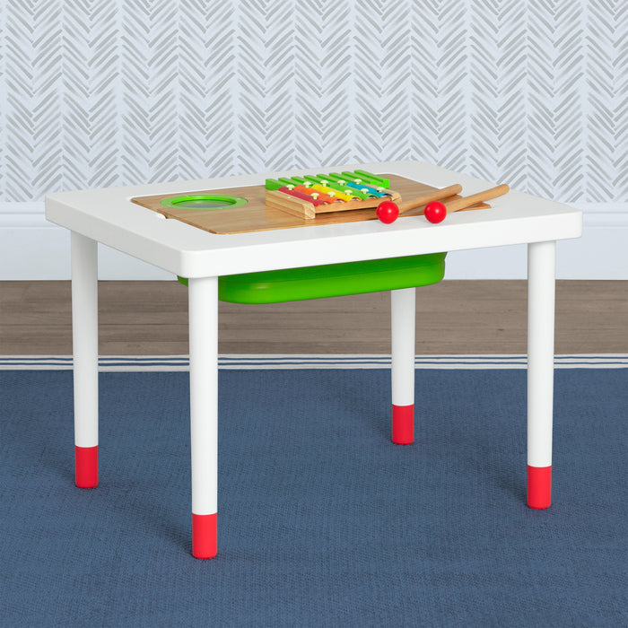 A compact sensory play and learn table with a white and red frame, green sensory board, and a collection of toys placed on top. 1-Compact Play & Learn Sensory Table for Kids