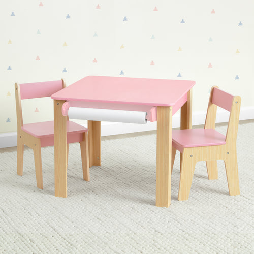 Children's table and chairs set with pink top and natural wood legs on a white carpet.