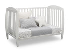 White crib with bedding and pillows on a white background 18-Taylor 4-in-1 Convertible Crib