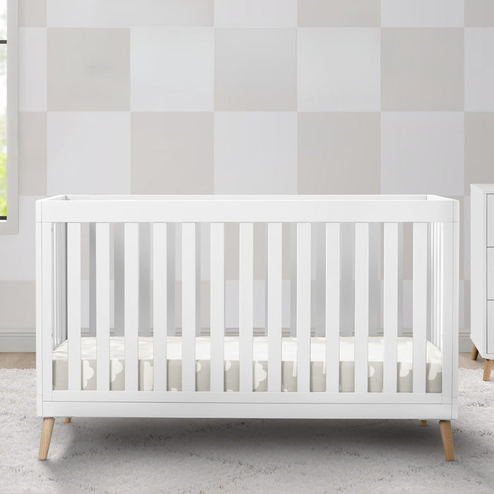 White crib in a room with striped wallpaper 3-Essex 4-in-1 Convertible Crib