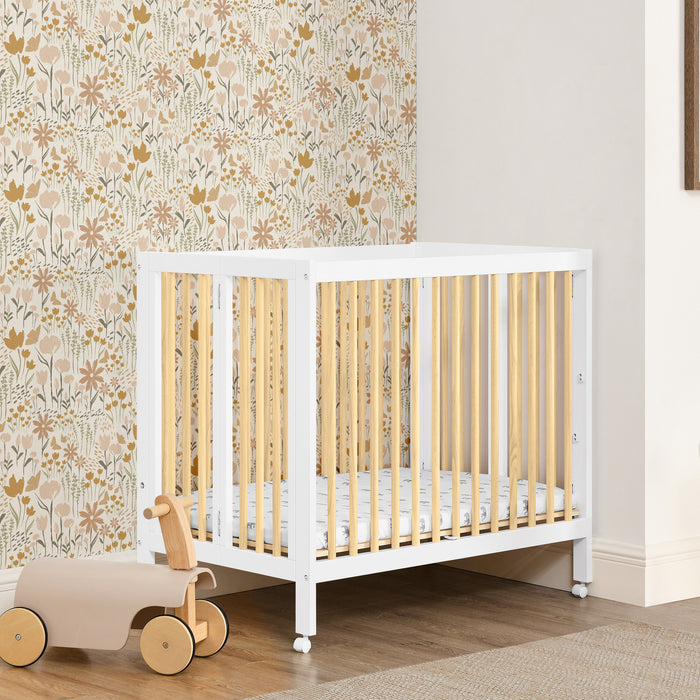 W105550 123 Mia Portable Mini Crib Bianca White wNatural Lifestyle 111 1-Mia Portable Folding Mini Crib with 1.5-Inch Mattress