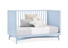Light blue crib with bedding and pillows on a white background 27-Dylan 4-in-1 Convertible Crib