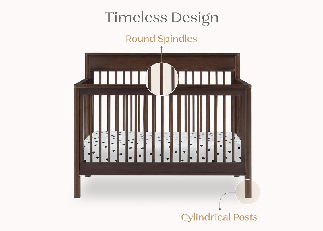 Wooden crib with round spindles on a white background
