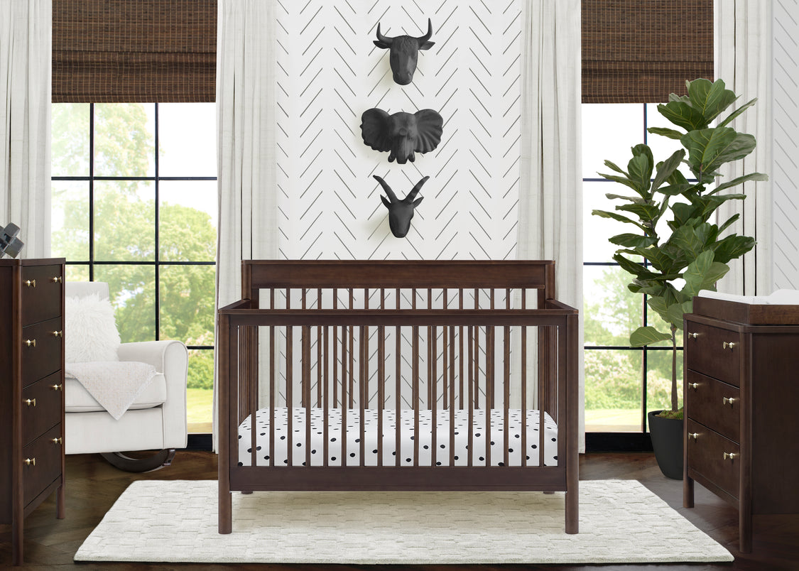Nursery room with a wooden crib, dresser, and decorative wall art.
