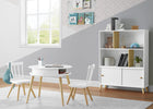 White dining set with table and chairs in a room with a bookshelf and window. 10-Essex Bookcase