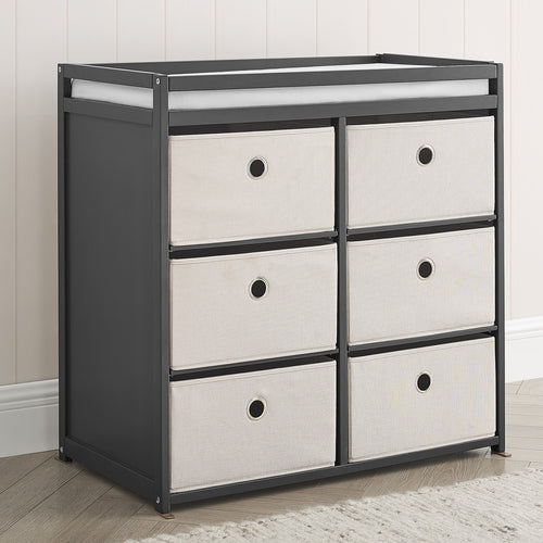 A white fabric bin changer with multiple drawers, featuring safety rails and a minimalistic design.