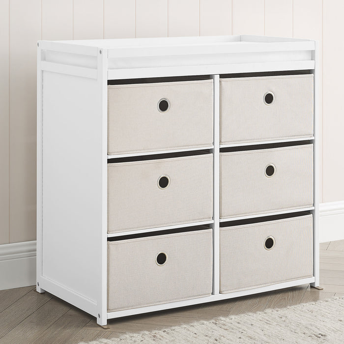 A white fabric bin changer with multiple drawers, featuring safety rails and a minimalistic design. 2-Hayes Fabric Bin Changer
