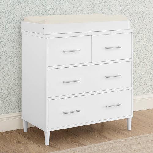 White dresser with four drawers against a light gray wall.