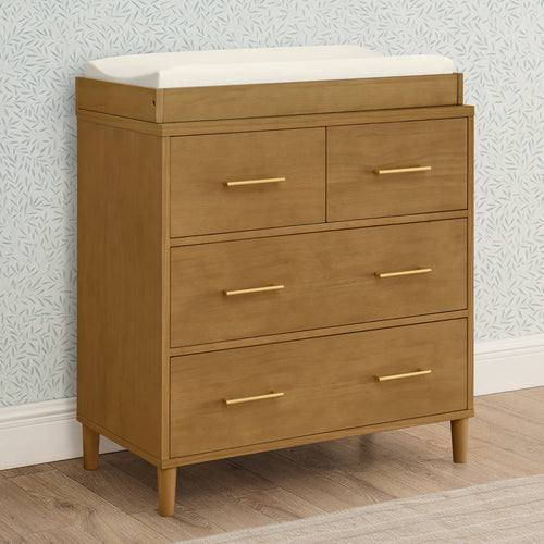 Wooden dresser with white top against a patterned wall