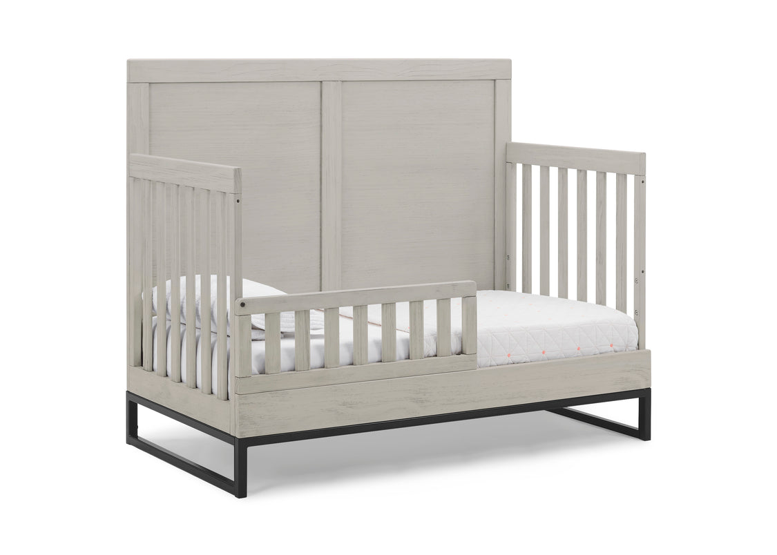 Gray crib with white mattress on a white background