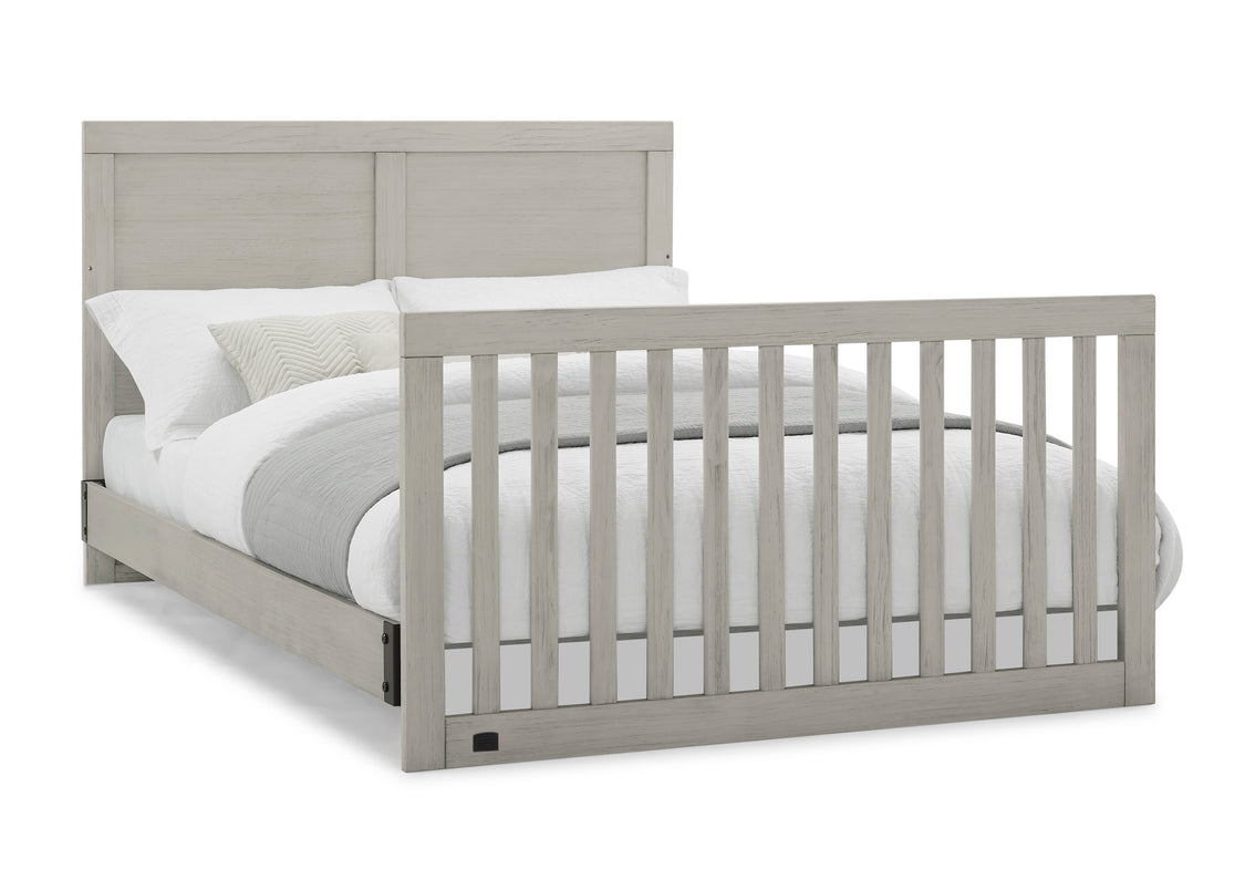 Gray crib with white mattress on a white background