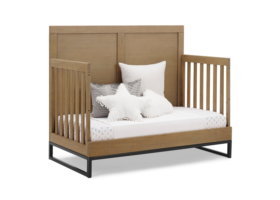 Wooden crib with white bedding and pillows on a white background