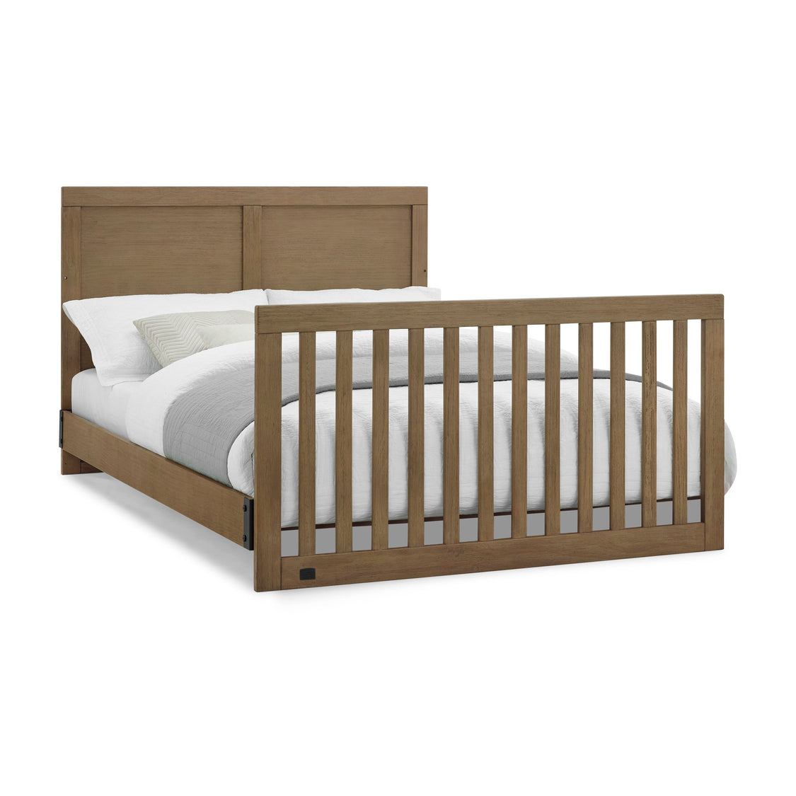 Wooden crib with white bedding on a white background