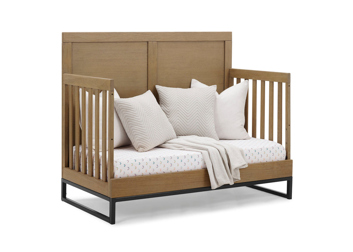 Wooden crib with white bedding and pillows on a white background