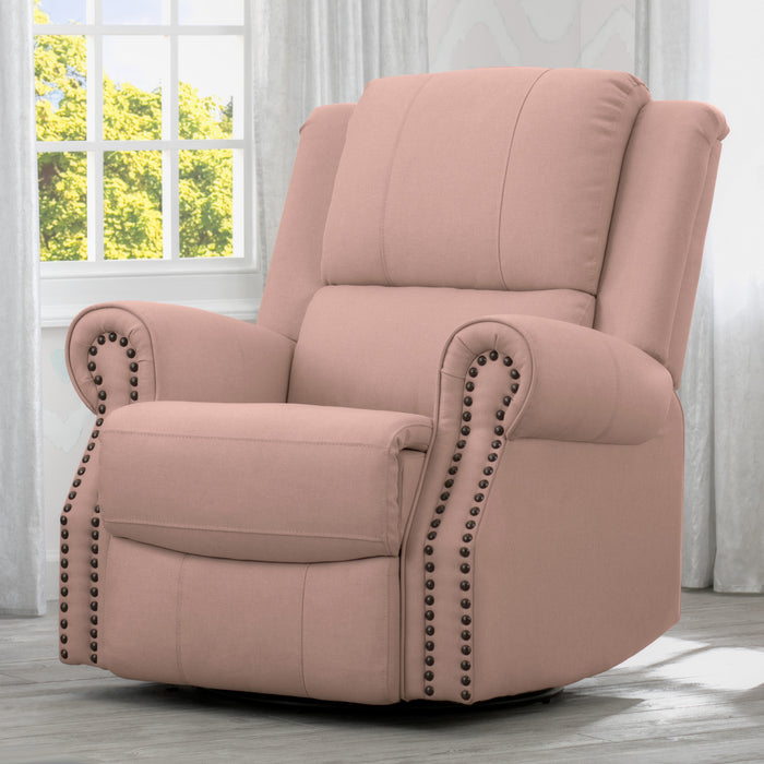 A beige upholstered recliner glider swivel chair with cushioned arms and nailhead trim, positioned in a nursery room. 1-Dylan Nursery Recliner Glider Swivel Chair