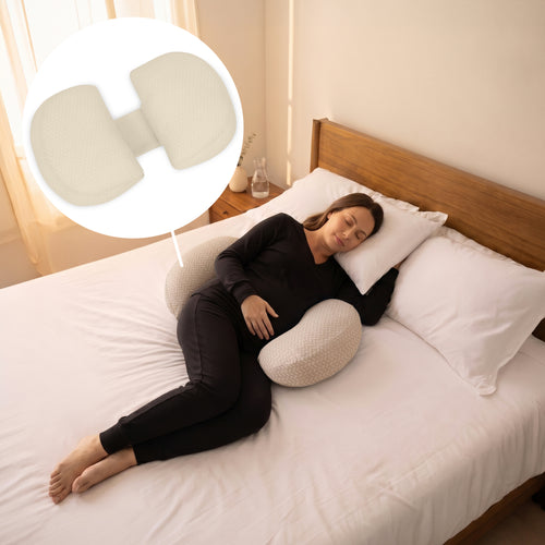 A woman sleeping on a bed using a beige contoured maternity pillow, with a circular inset showing a close-up of the textured fabric and double side design.