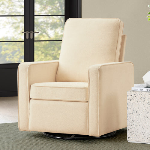 A cream-colored fabric swivel glider armchair with a high backrest, shown in a modern living room setting next to a speckled side table.