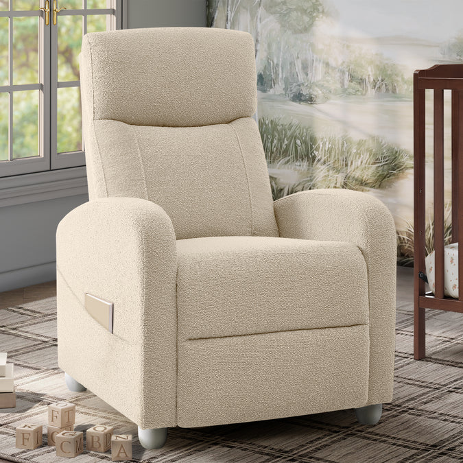 A cream-colored upholstered recliner chair with a side pocket, shown in a styled room setting with a window, rug, and wall art in the background. 14-Riley Pushback Stationary Recliner