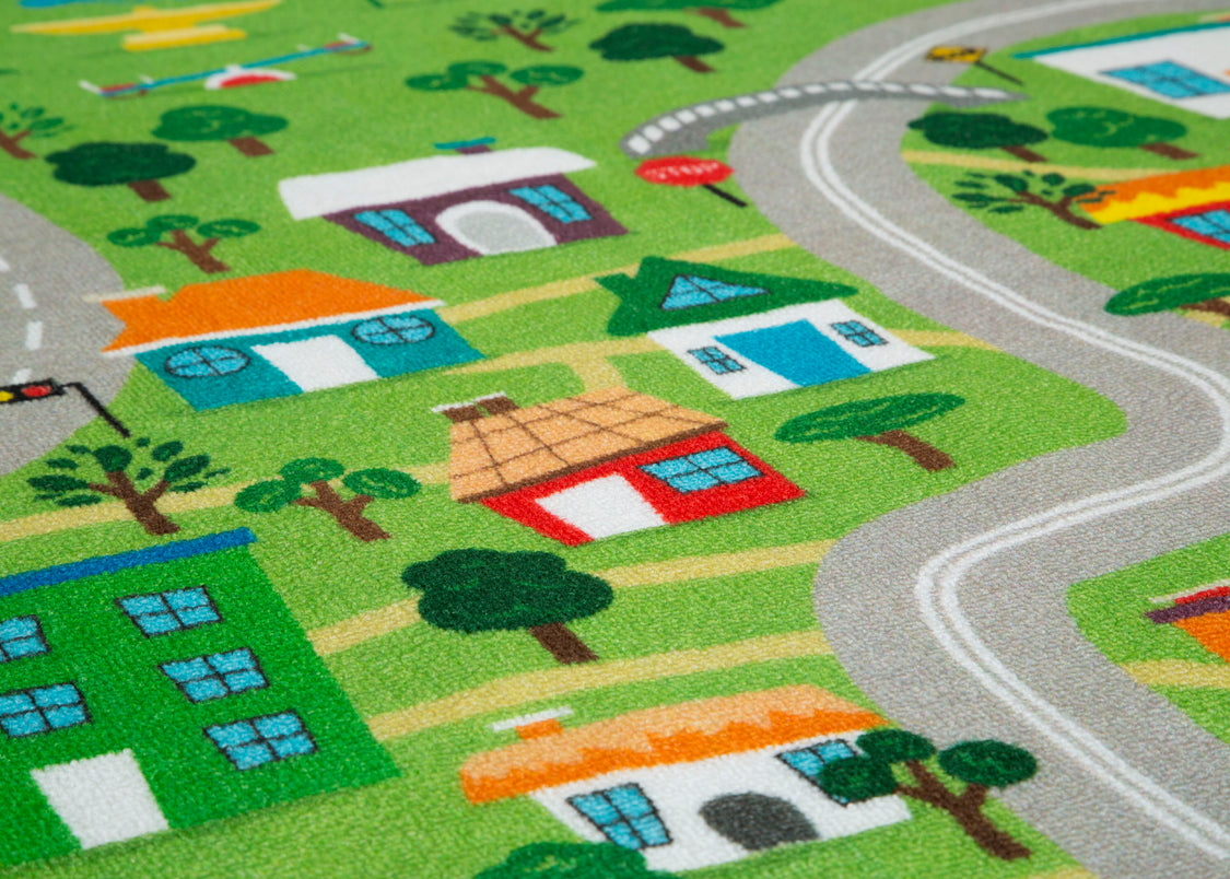 Children's play rug with a town layout featuring houses, roads, and trees.