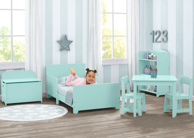 Children's room with mint green furniture including a bed, table, and chairs.