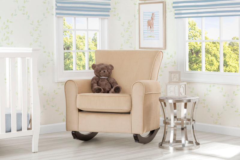 Beige armchair with a teddy bear in a nursery room with striped window blinds and a crib. 10-Lancaster Rocking Chair featuring LiveSmart Fabric by Culp