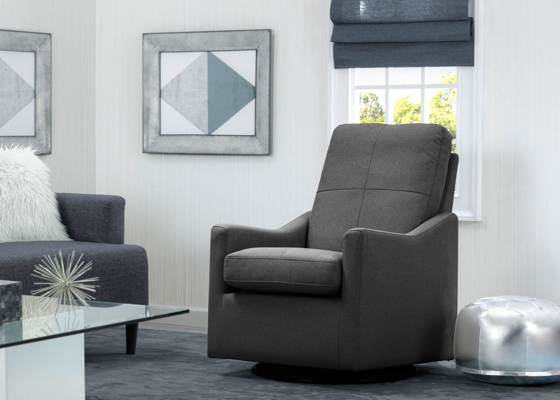 Gray armchair in a living room setting with a glass coffee table and decorative elements.