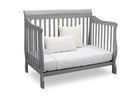 Gray crib with white mattress and pillows on a white background 28-Canton 4-in-1 Crib