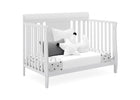 White crib with decorative pillows on a white background 21-Richmond 6-in-1 Convertible Baby Crib