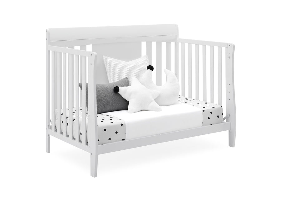 White crib with decorative pillows on a white background 21-Richmond 6-in-1 Convertible Baby Crib